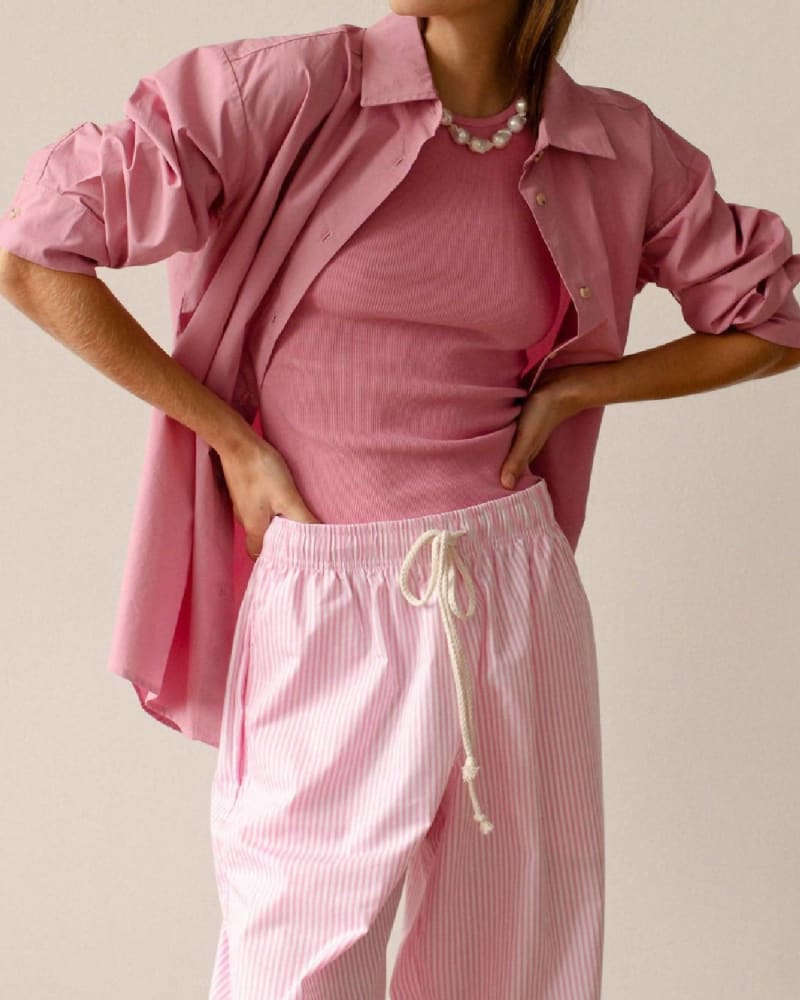 Front of a model wearing a size L Pop Button Down Shirt in Bonbon in Bonbon by DONNI.. | dia_product_style_image_id:333554